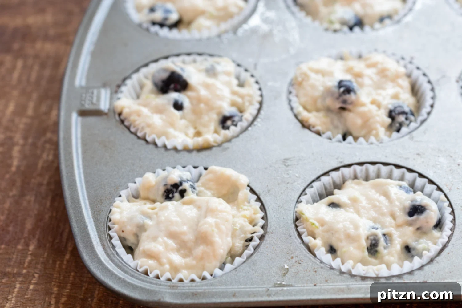 Batter for our Vegan Blueberry Muffins in muffin pan