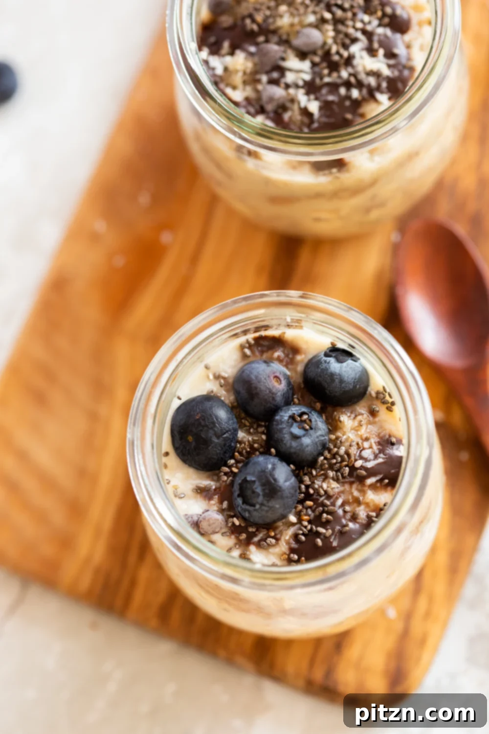 Decadent Samoa Cookie Overnight Oats 3 Our Vegan Samoa Cookie Overnight Oats in glass jars on a wood board