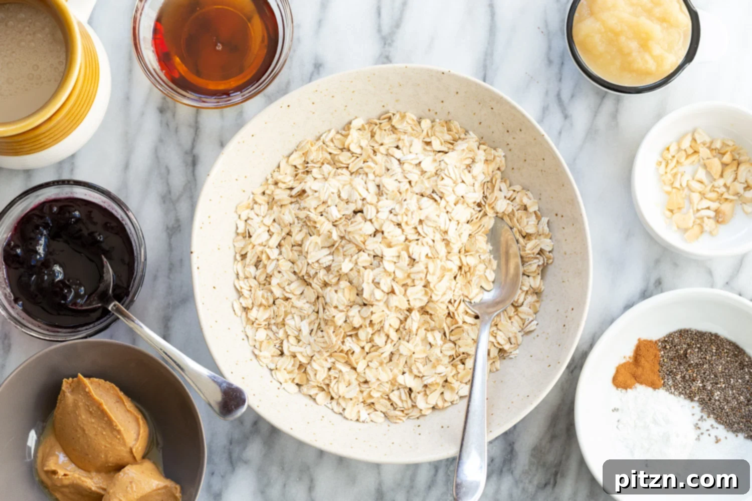 Dry ingredients for Peanut Butter and Jelly Oatmeal in separate bowls, ready for mixing.
