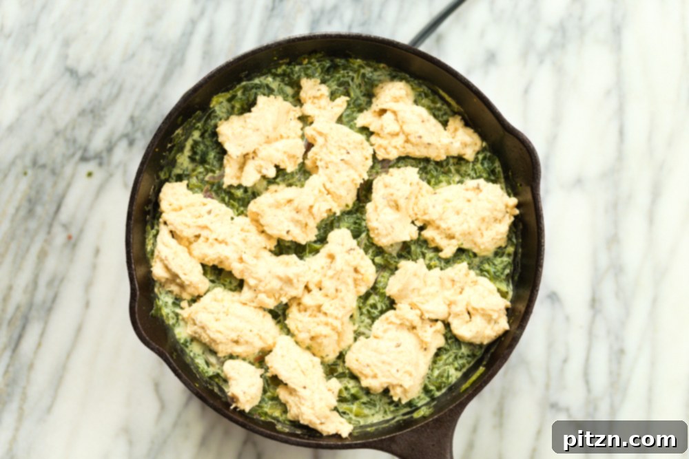 Biscuit topped Creamed spinach in cast iron skillet