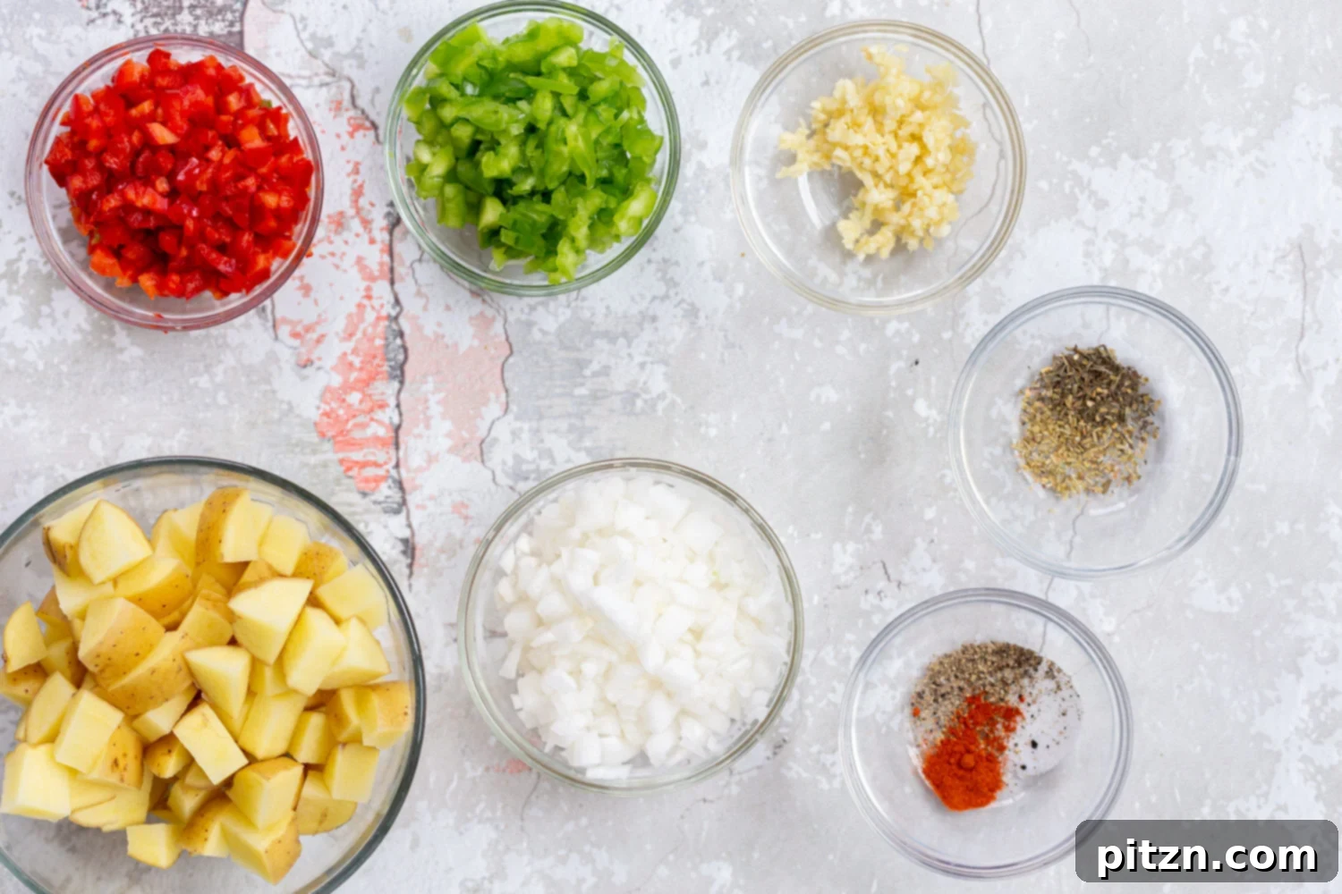Bowls of prepped ingredients for a vegan mung omelet, including chopped vegetables and spices