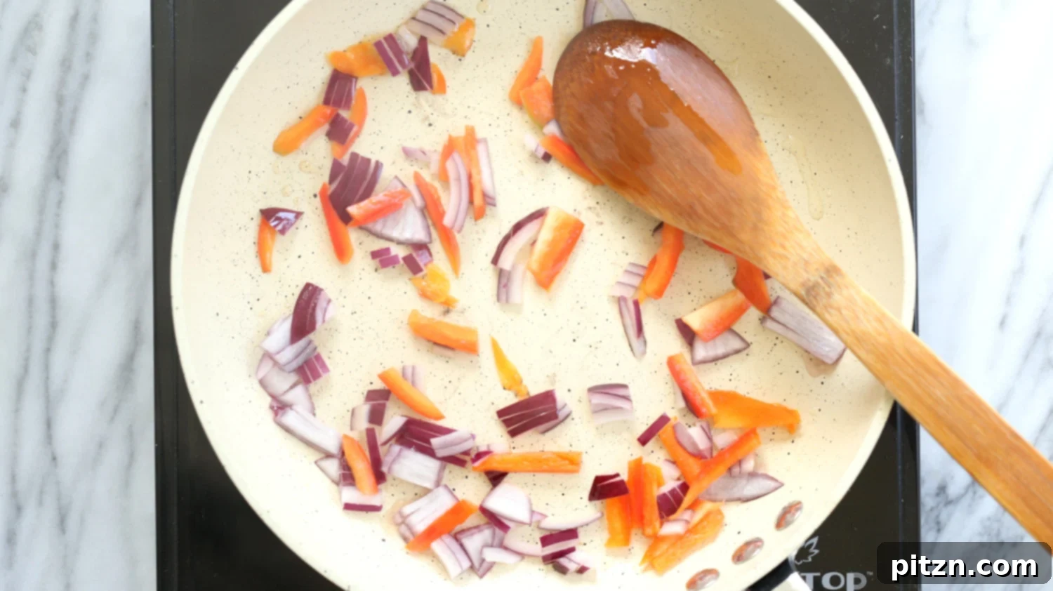 Assorted fresh vegetables chopped and ready for inclusion in a delicious Vegan Omelet, waiting in a white skillet