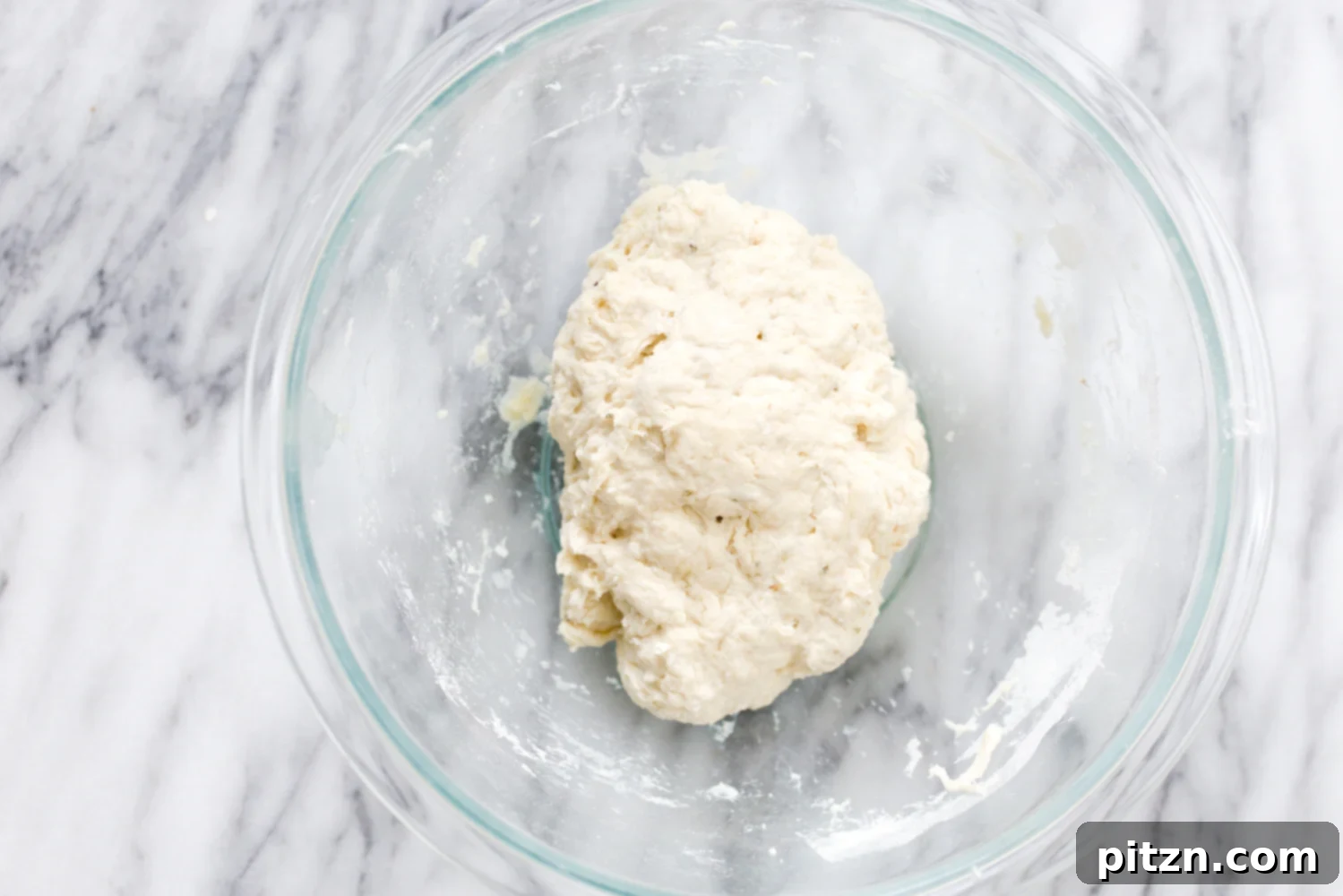 Easy Vegan Pizza Dough 3 overhead shot of a glass bowl with vegan pizza dough