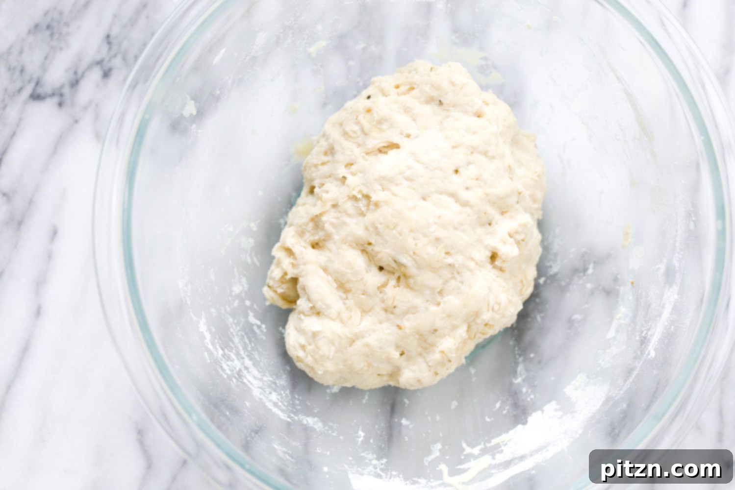 no yeast pizza dough vegan yeast-free pizza dough being mixed in a glass bowl