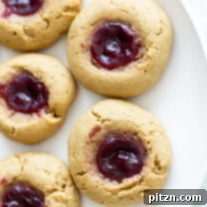 overhead shot of a plate of vegan peanut butter jelly thumbprint cookies