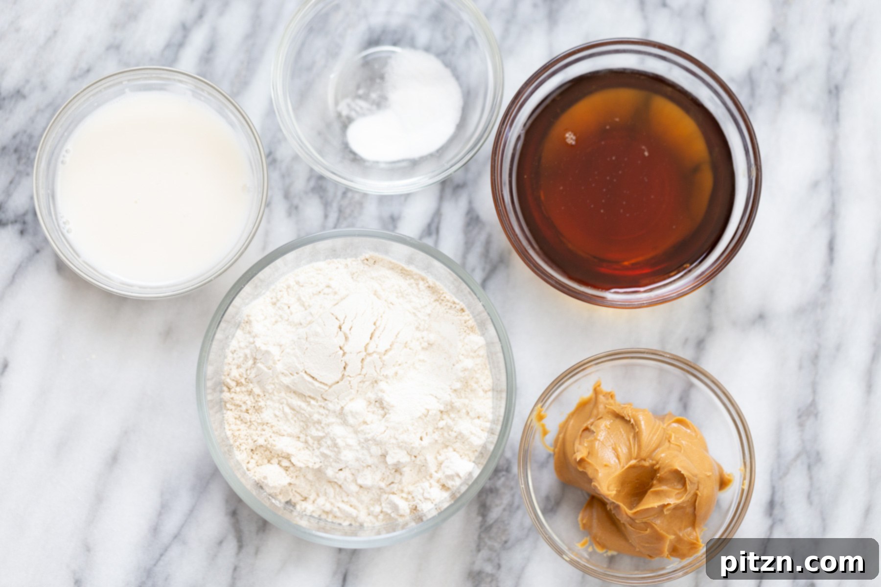 Ingredients for making vegan thumbprint cookies on a marble counter