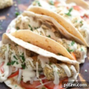 vegan chickpea croquettes served in tortillas drizzled with tahini dill sauce