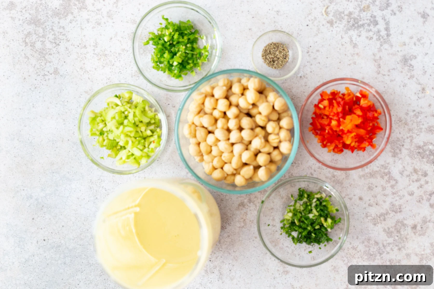 Vegan Chickpea Salad Ingredients Overhead shot of all ingredients laid out for making vegan chickpea salad, including canned chickpeas, vegetables, and tofu for the dip.