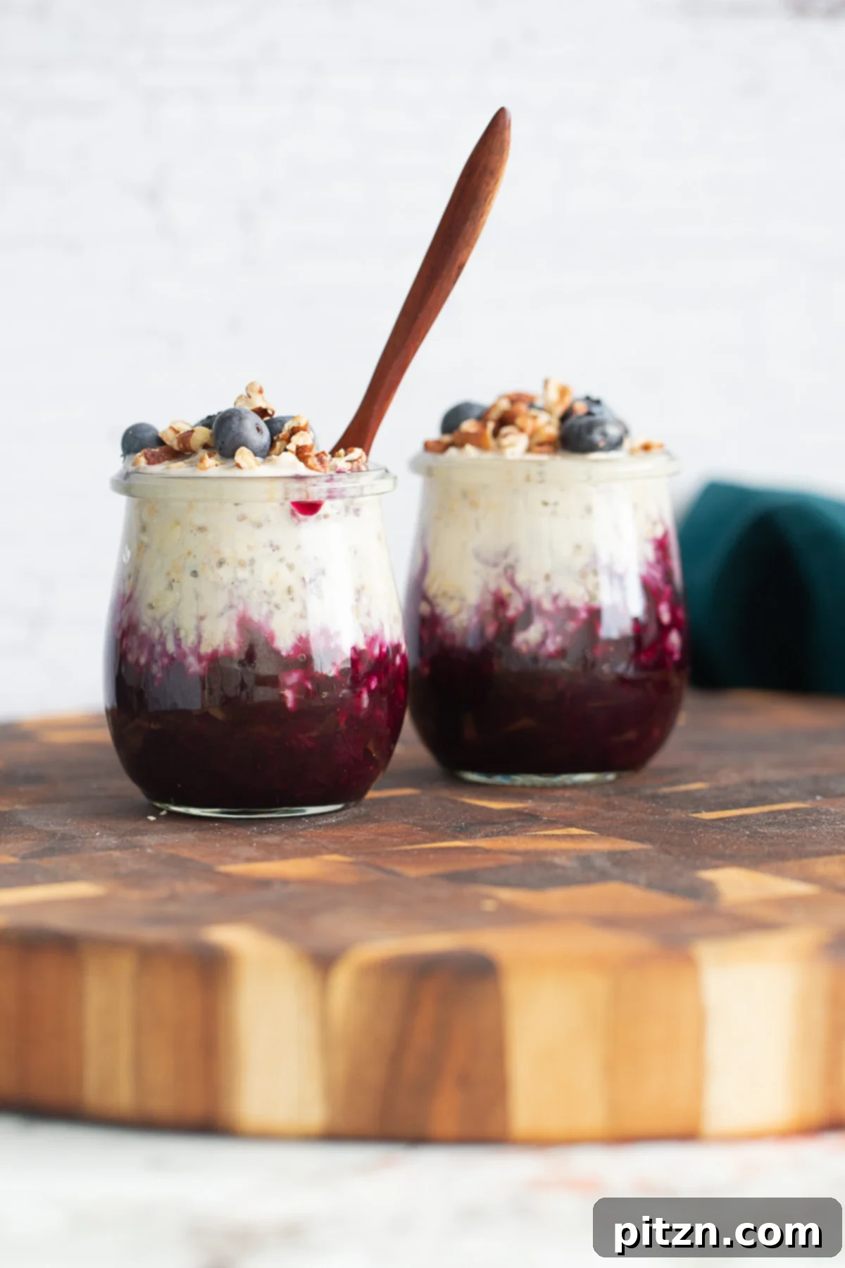 Blueberry Overnight Oats with Pecans Blueberry muffin overnight oats in a glass jar, generously topped with fresh blueberries and a scattering of chopped pecans for crunch and flavor