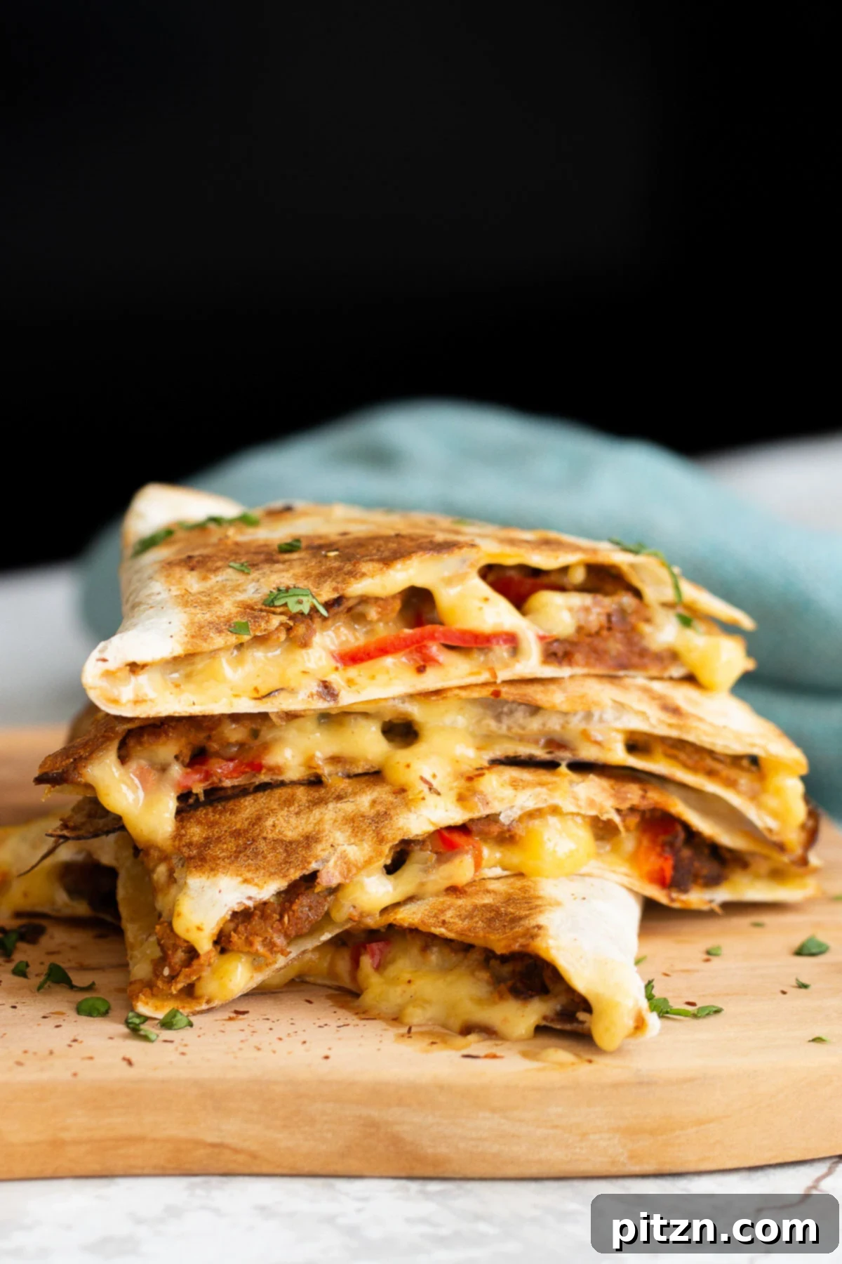 close-up side view of a stack of cut vegan walnut meat quesadillas