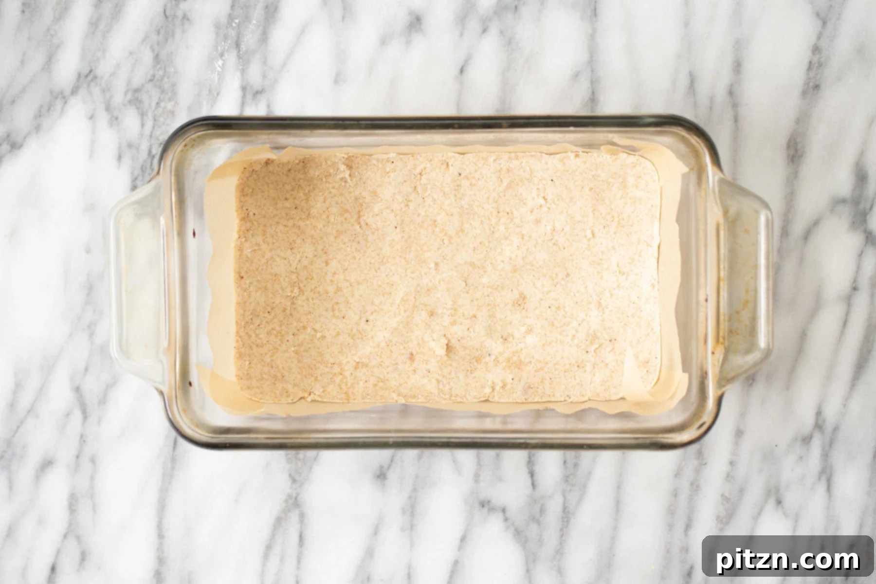 almond flour crust in a glass loaf pan