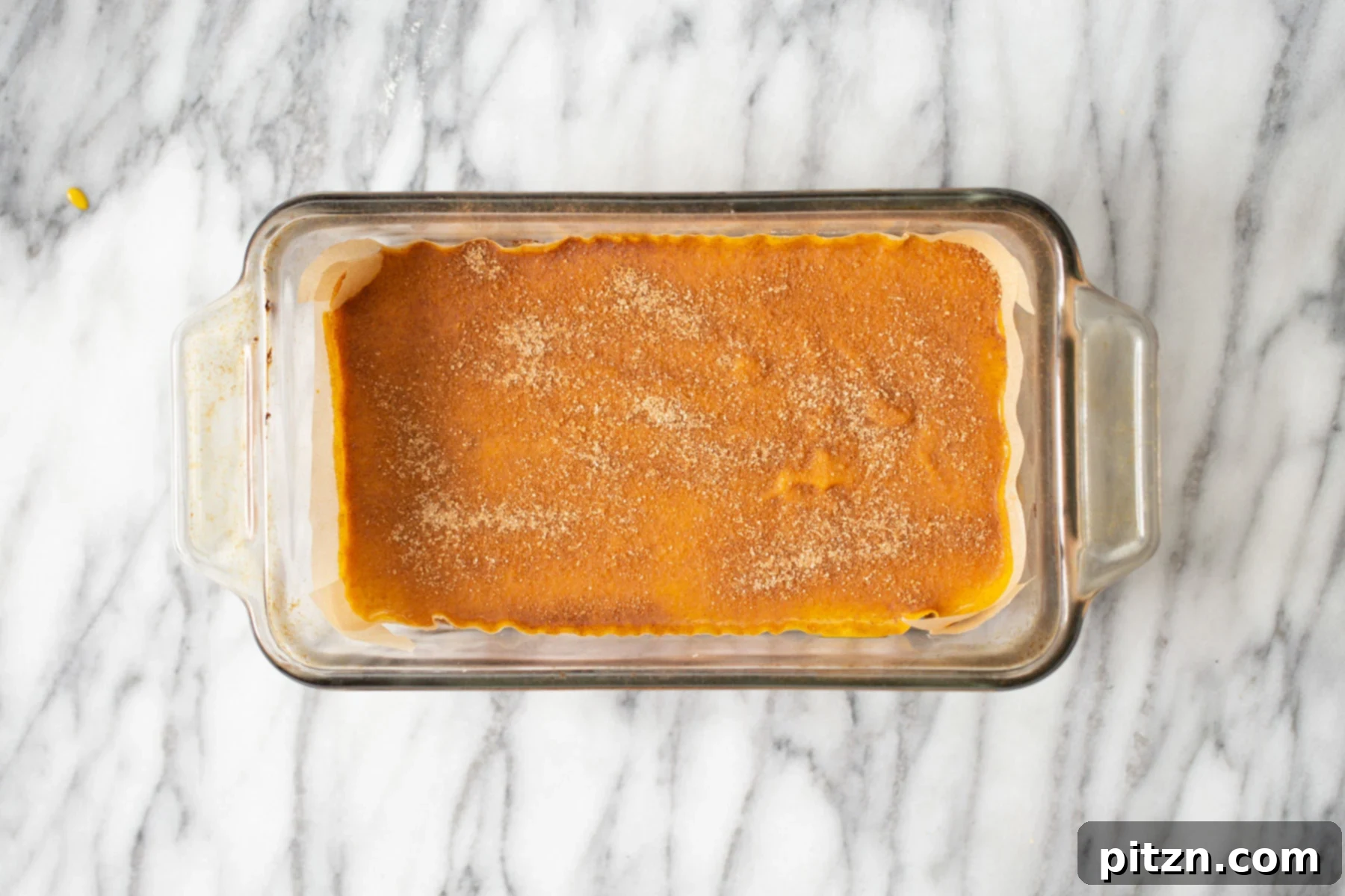 pumpkin pie filling being added to crust in loaf pan