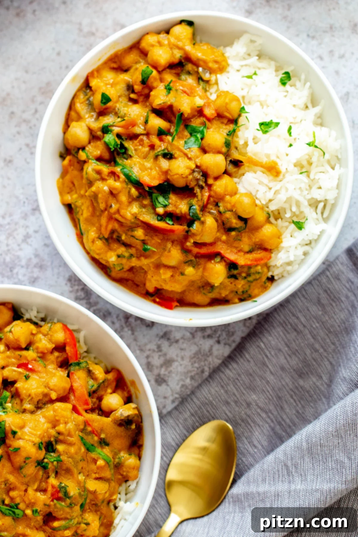 Hearty Vegan Pumpkin Curry Overhead shot of two bowls of creamy vegan pumpkin curry, beautifully presented.