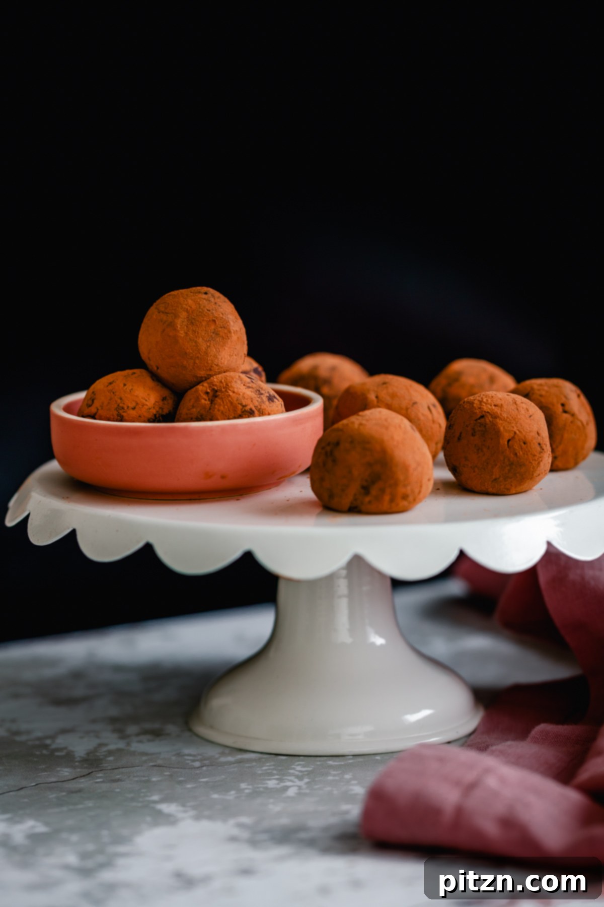tiramisu truffles a cake stand with cocoa-dusted vegan Tiramisu truffles made with vegan cream cheese