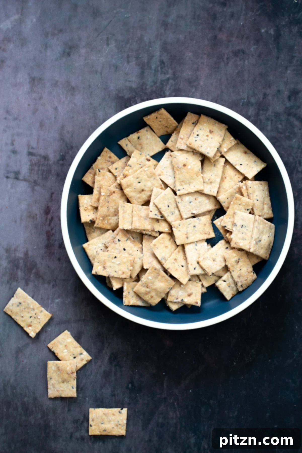 a bowl with vegan everything bagel crackers 