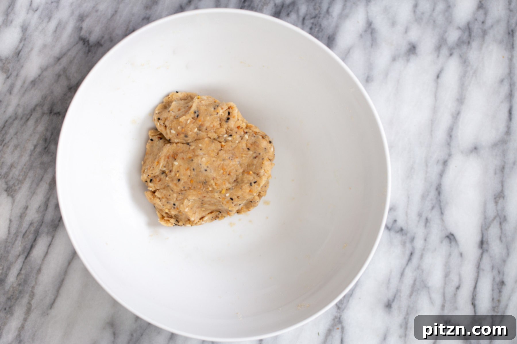 vegan everyrhing bagel cracker dough in a small white bowl 