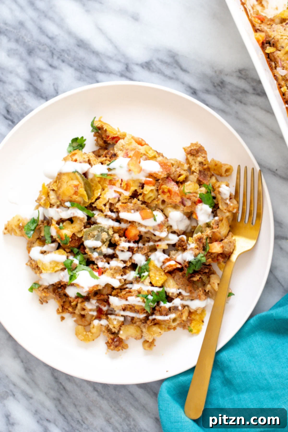 a serving of vegan taco mac and cheese casserole with a fork on the side