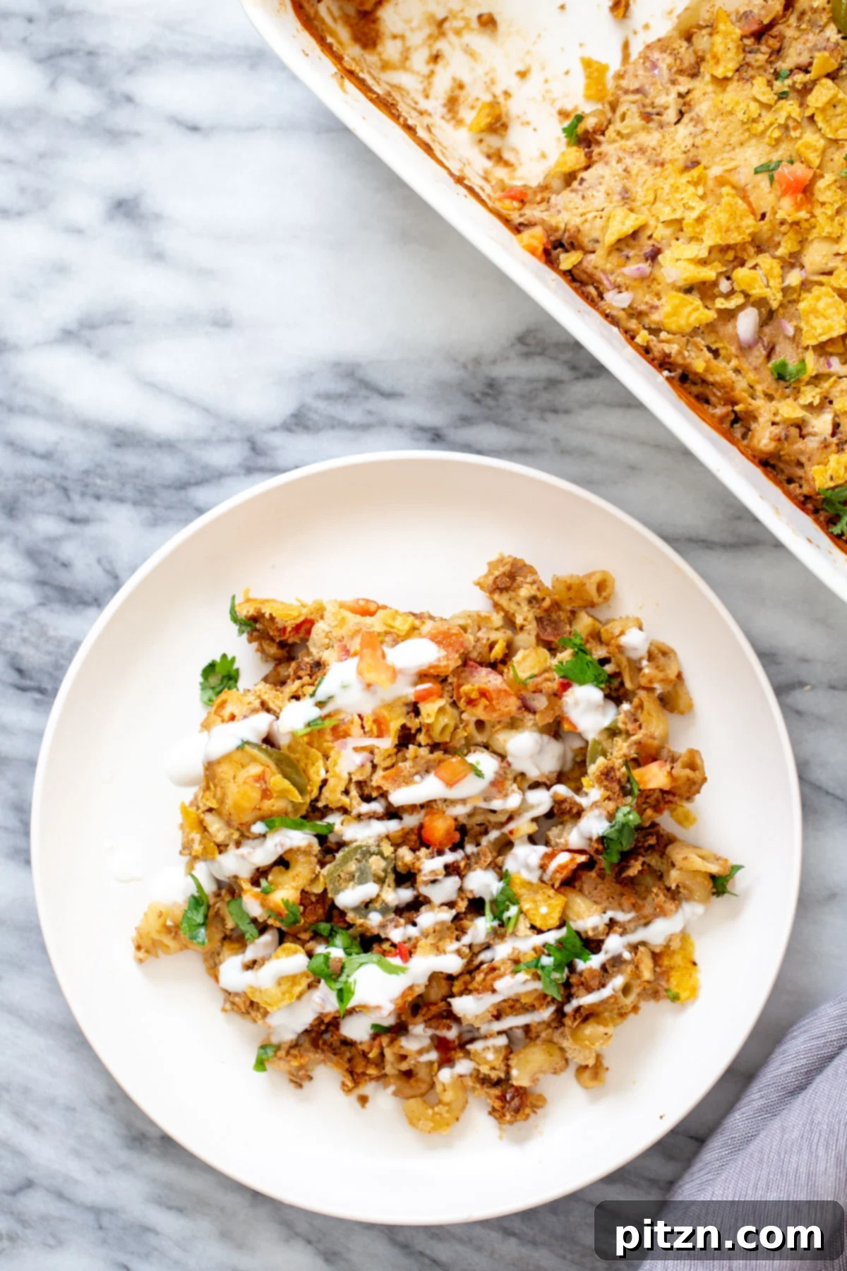 a serving of vegan taco bake with walnut taco meat and vegan cashew queso