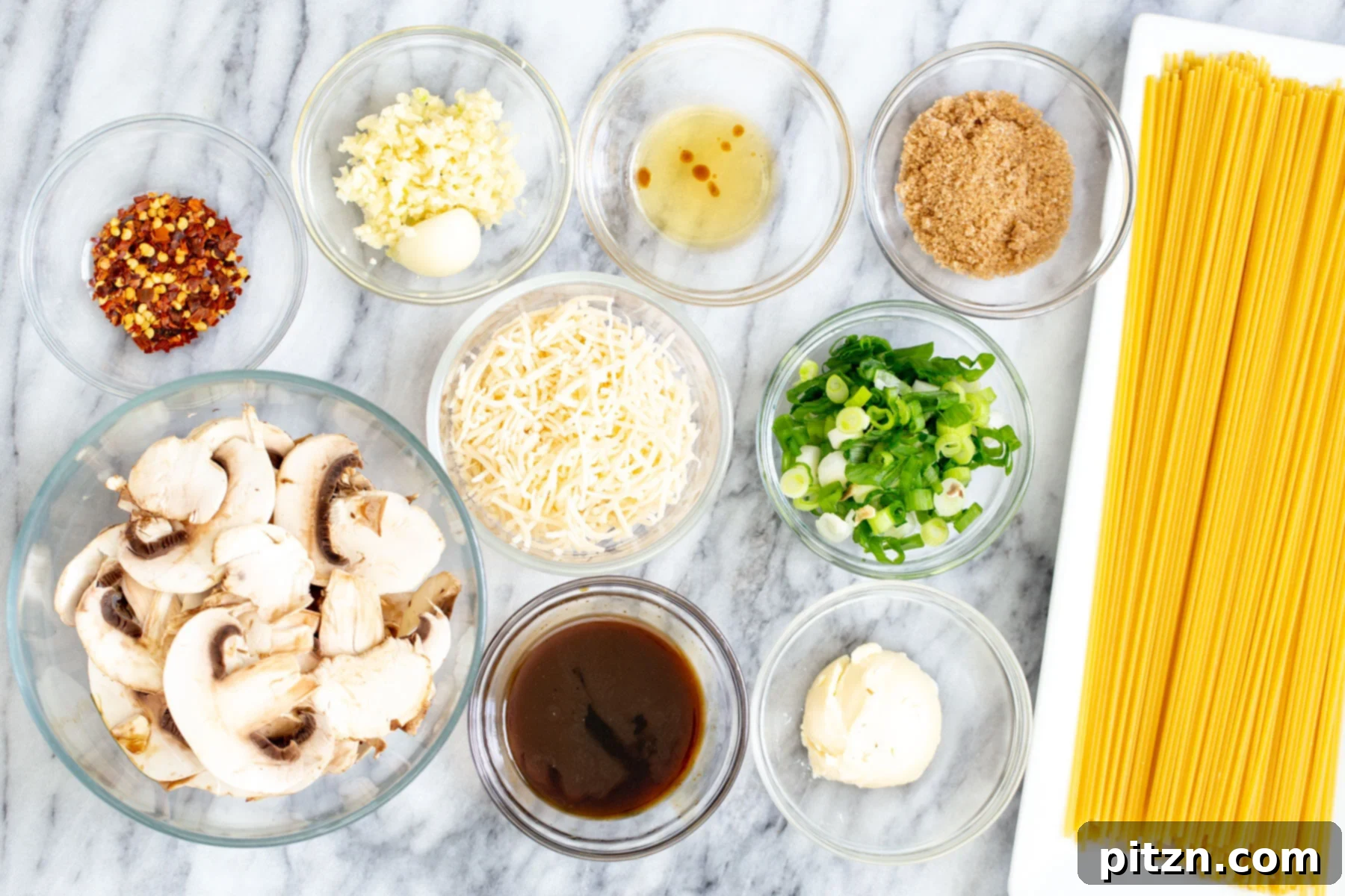 Ultimate Vegan Garlic Noodles 2 A flat lay photograph showcasing all the fresh and essential ingredients required to prepare a batch of delicious vegan garlic noodles.