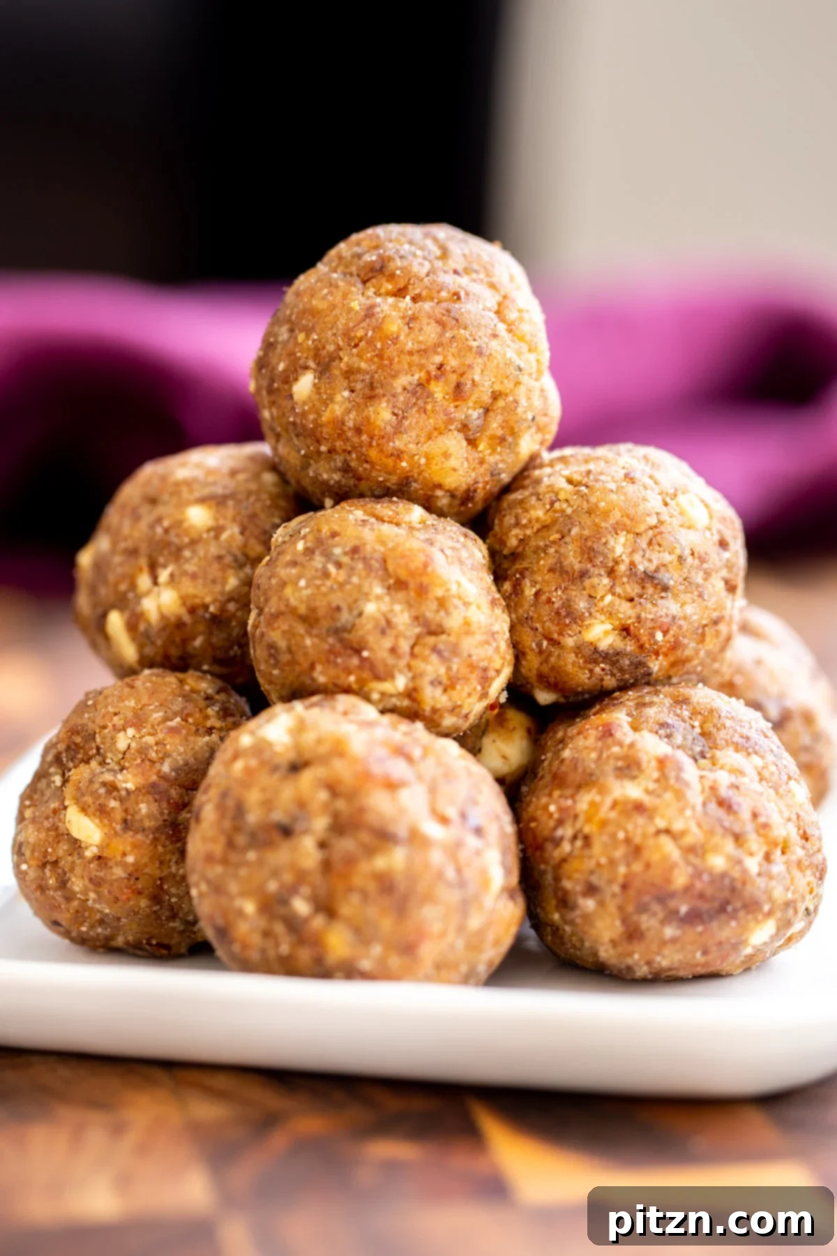 date ladoo A beautifully arranged plate featuring stacked vegan date ladoos, perfect for festive celebrations.