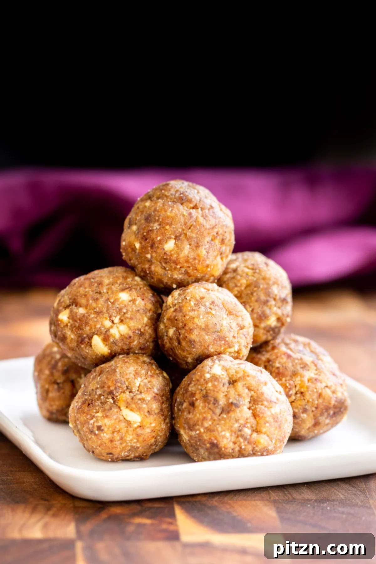 date ladoo A vibrant close-up of stacked vegan ladoos, beautifully sweetened with dates and ready to be enjoyed.
