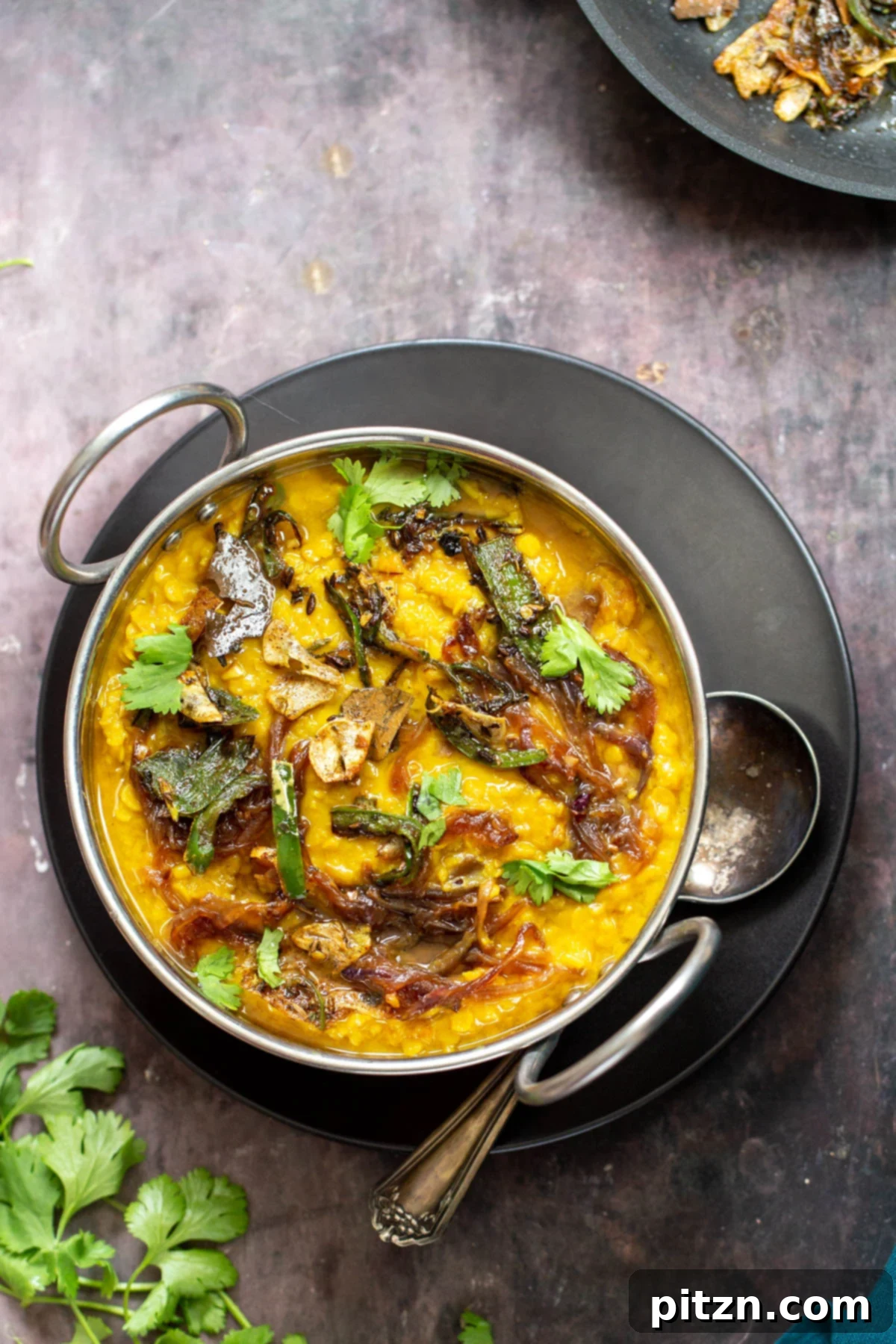 Restaurant-Style Masoor Dal Tadka in an Indian serving dish 