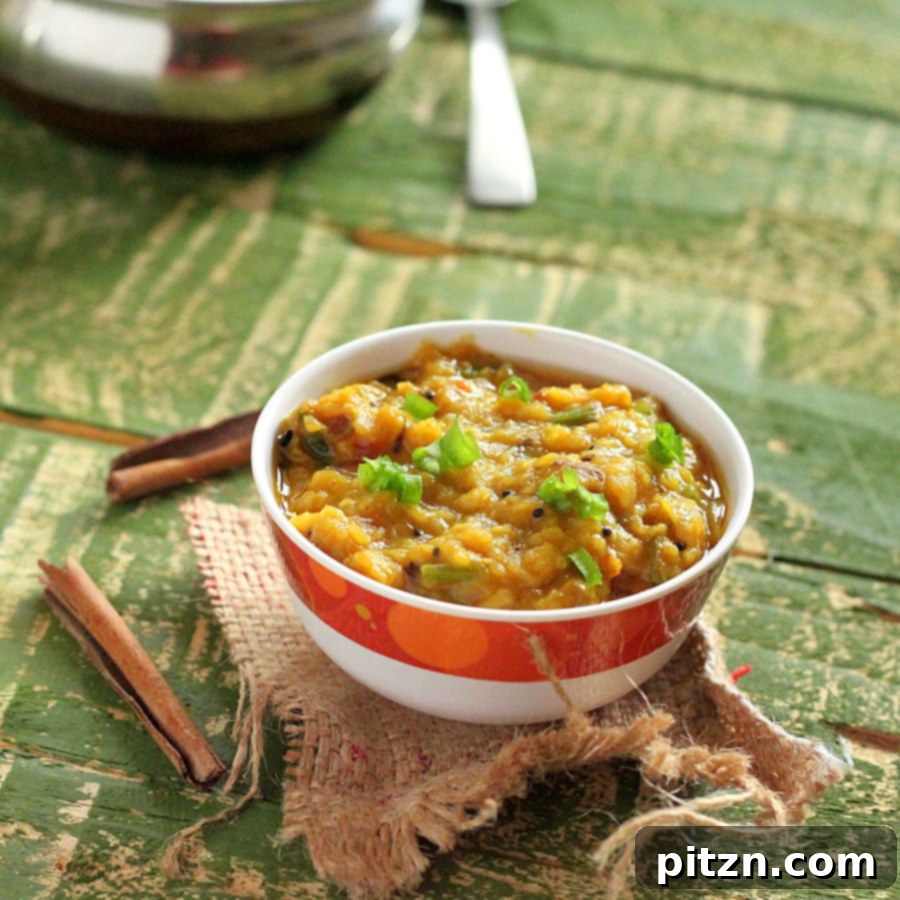 A vibrant bowl of red lentil stew, garnished with fresh herbs, showcasing its rich texture and color, set on a rustic background.