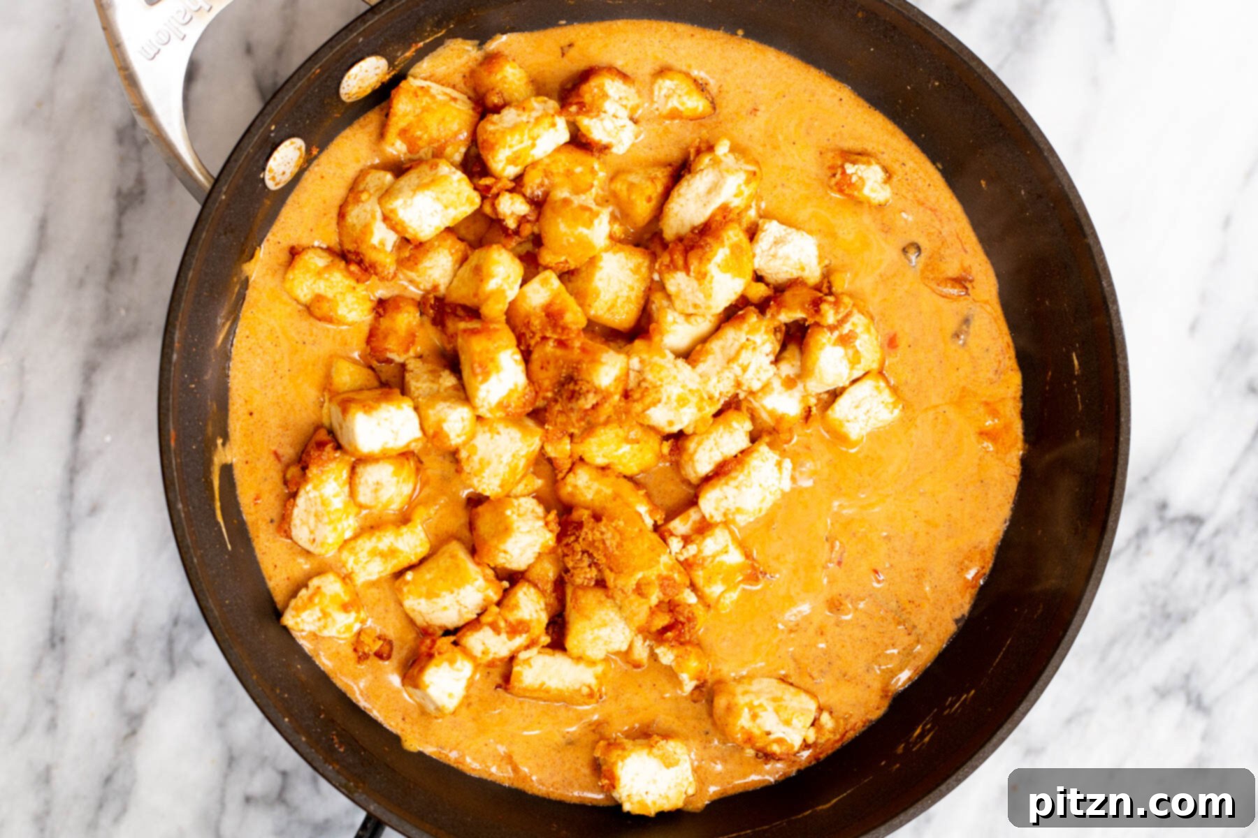 Vegan Tofu Rogan Josh 20 Crispy tofu cubes fully immersed in the creamy, rich vegan Rogan Josh sauce, simmering gently.