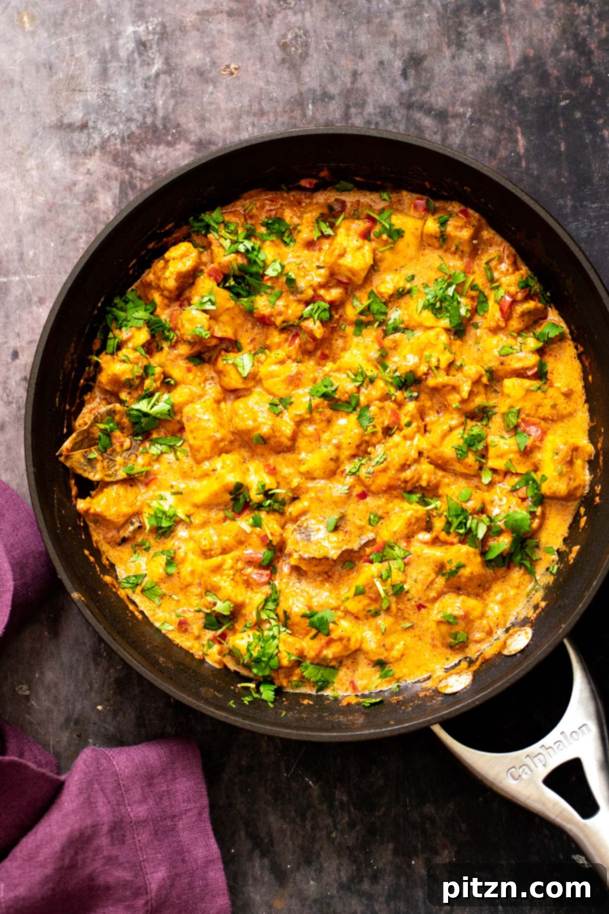 Vegan Tofu Rogan Josh 23 A skillet full of simmering vegan Rogan Josh, generously sprinkled with fresh cilantro, ready to be served.