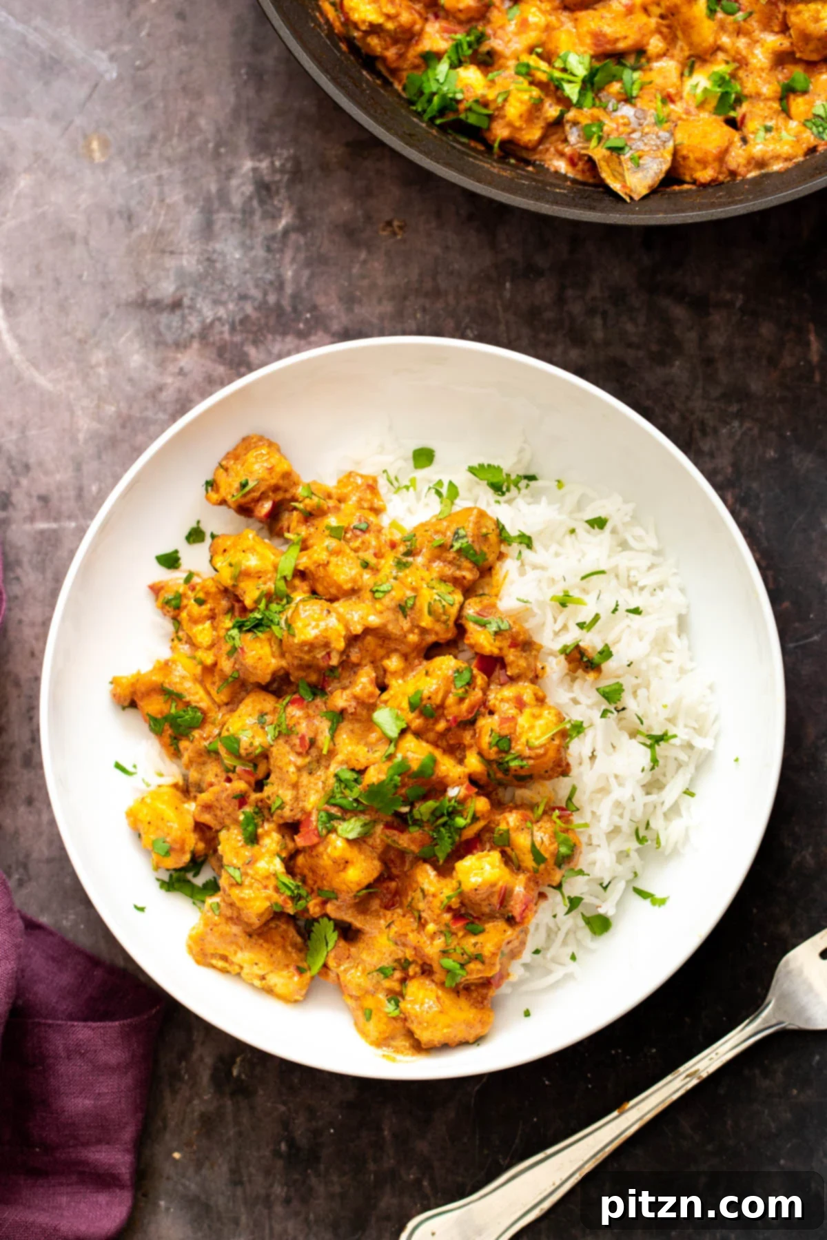 Vegan Tofu Rogan Josh 6 Vegan Rogan Josh served with rice and garnished with fresh cilantro, invitingly presented.