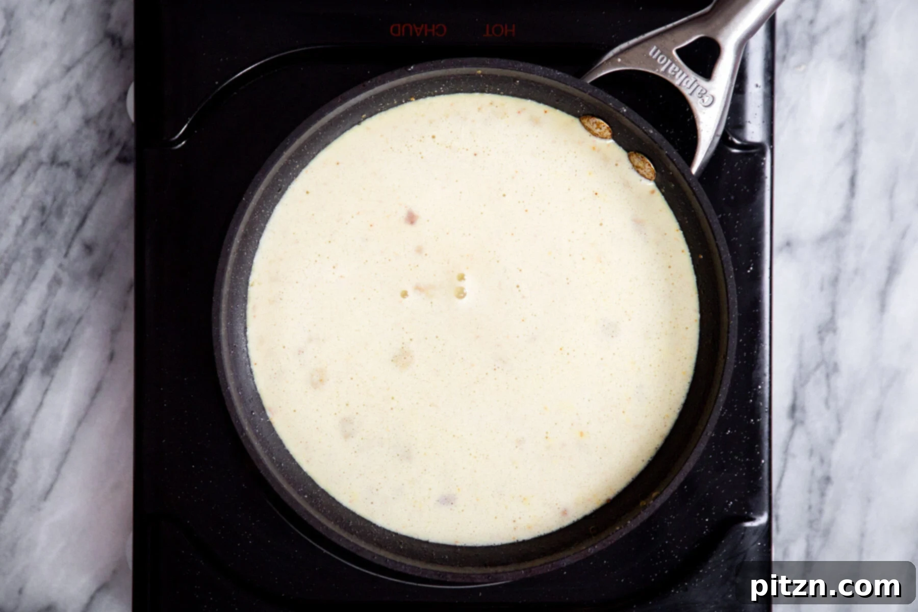 Shahi Tukda Royal Golden Toasts with Rabri Custard 12 Creamy vegan Rabri custard simmering in a small saucepan.