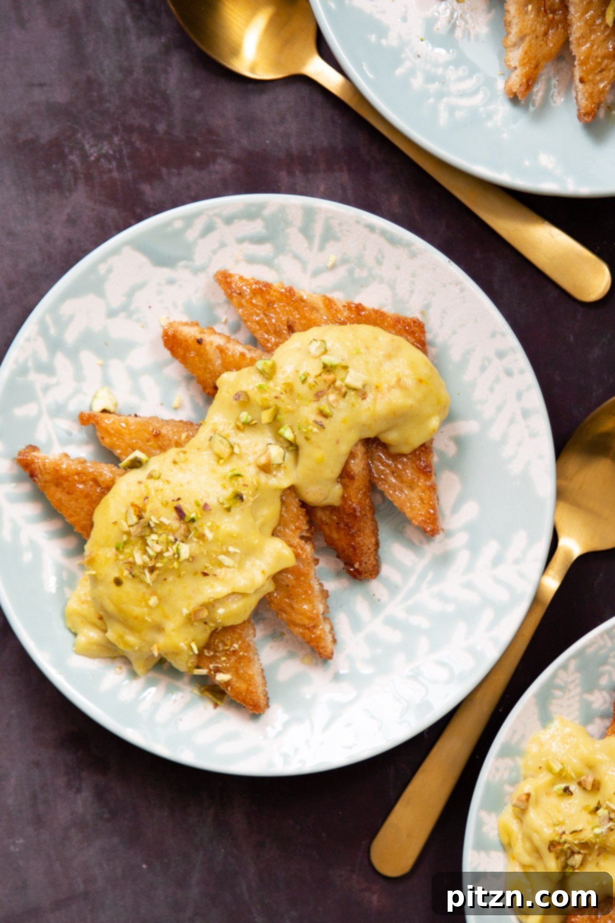 Shahi Tukda Royal Golden Toasts with Rabri Custard 13 A beautifully plated slice of Vegan Shahi Tukda, topped with luscious custard and sprinkled with green pistachios.