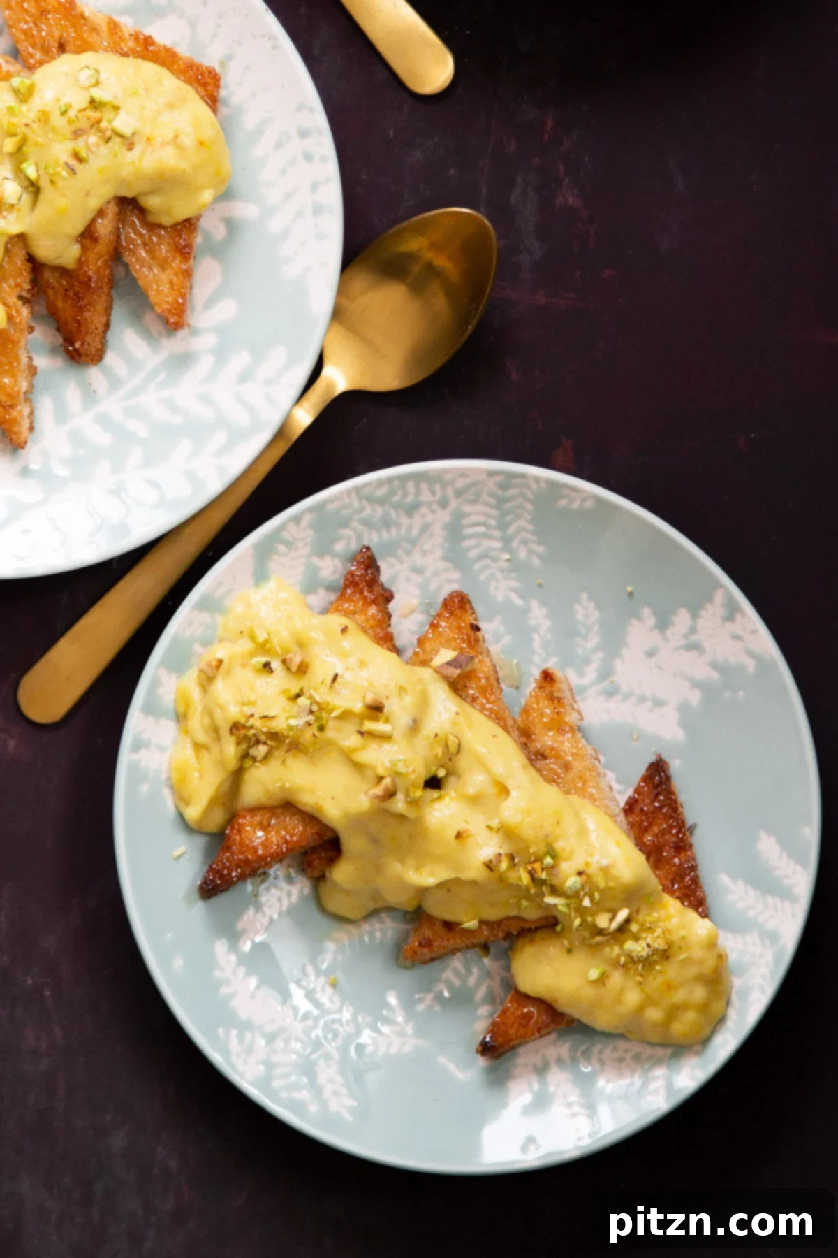 Shahi Tukda Royal Golden Toasts with Rabri Custard 4 A close-up of a Shahi Tukda slice, brushed with cardamom syrup and generously topped with saffron cashew Rabri, garnished with chopped pistachios.