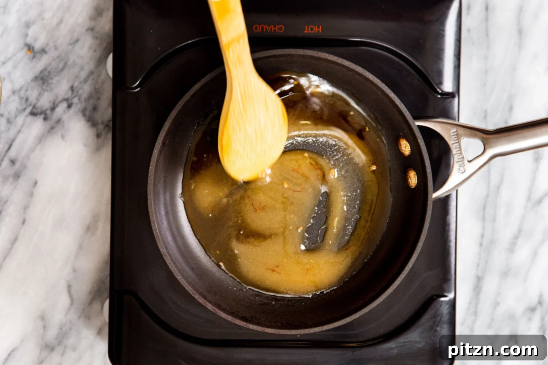 Shahi Tukda Royal Golden Toasts with Rabri Custard 8 Sugar syrup simmering in a small saucepan on a stovetop.