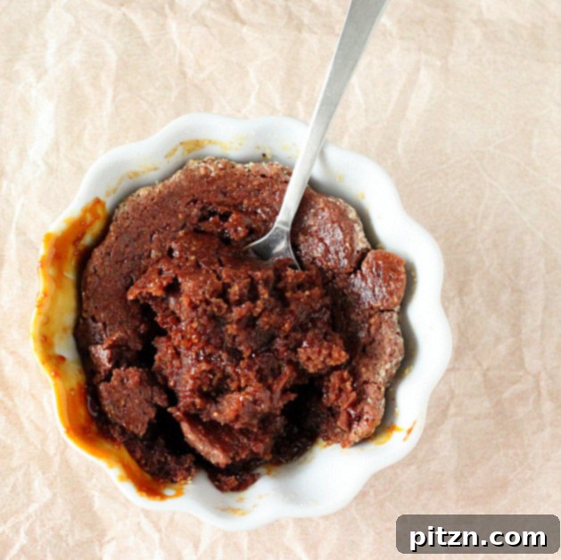 Close-up of an oozing salted caramel molten lava cake, showing the flowing caramel.
