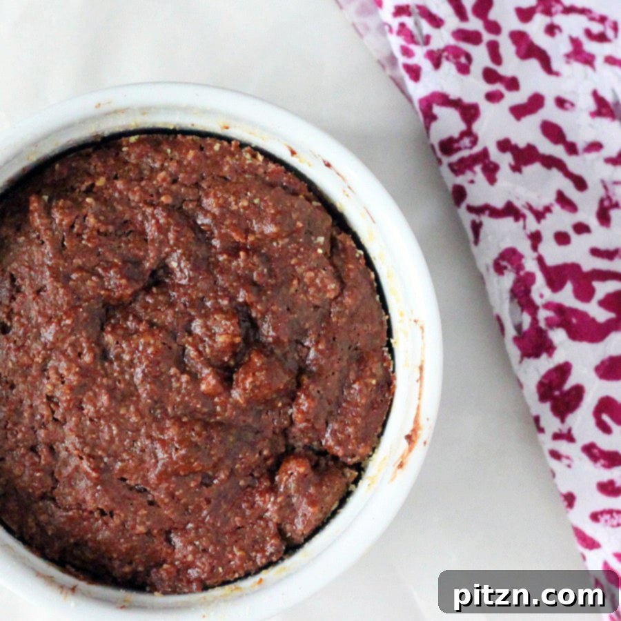 A freshly baked molten lava cake, still in its ramekin, ready to be enjoyed.