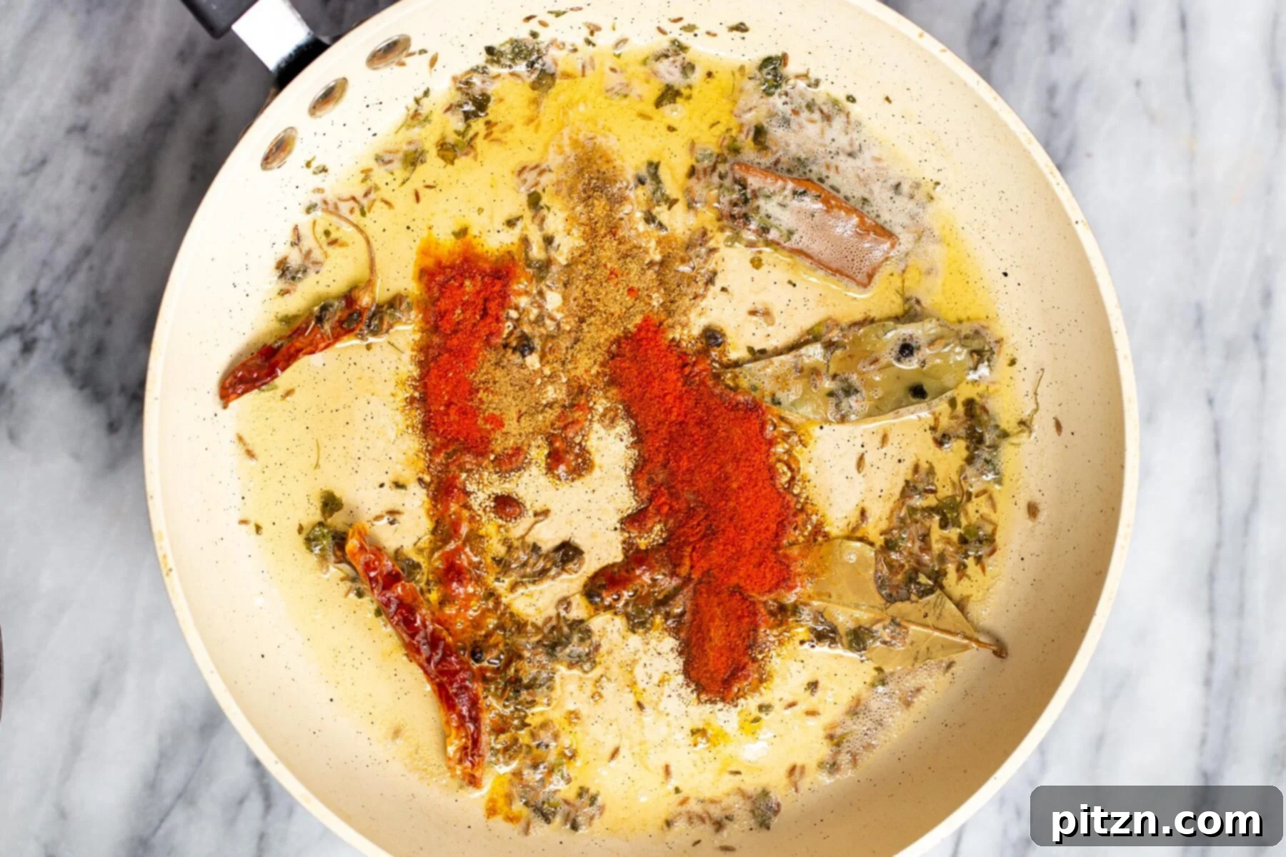 Creamy Plant-Based Dhaba Dal 13 Ground spices being added to the tempering mixture in a pan for dal recipe
