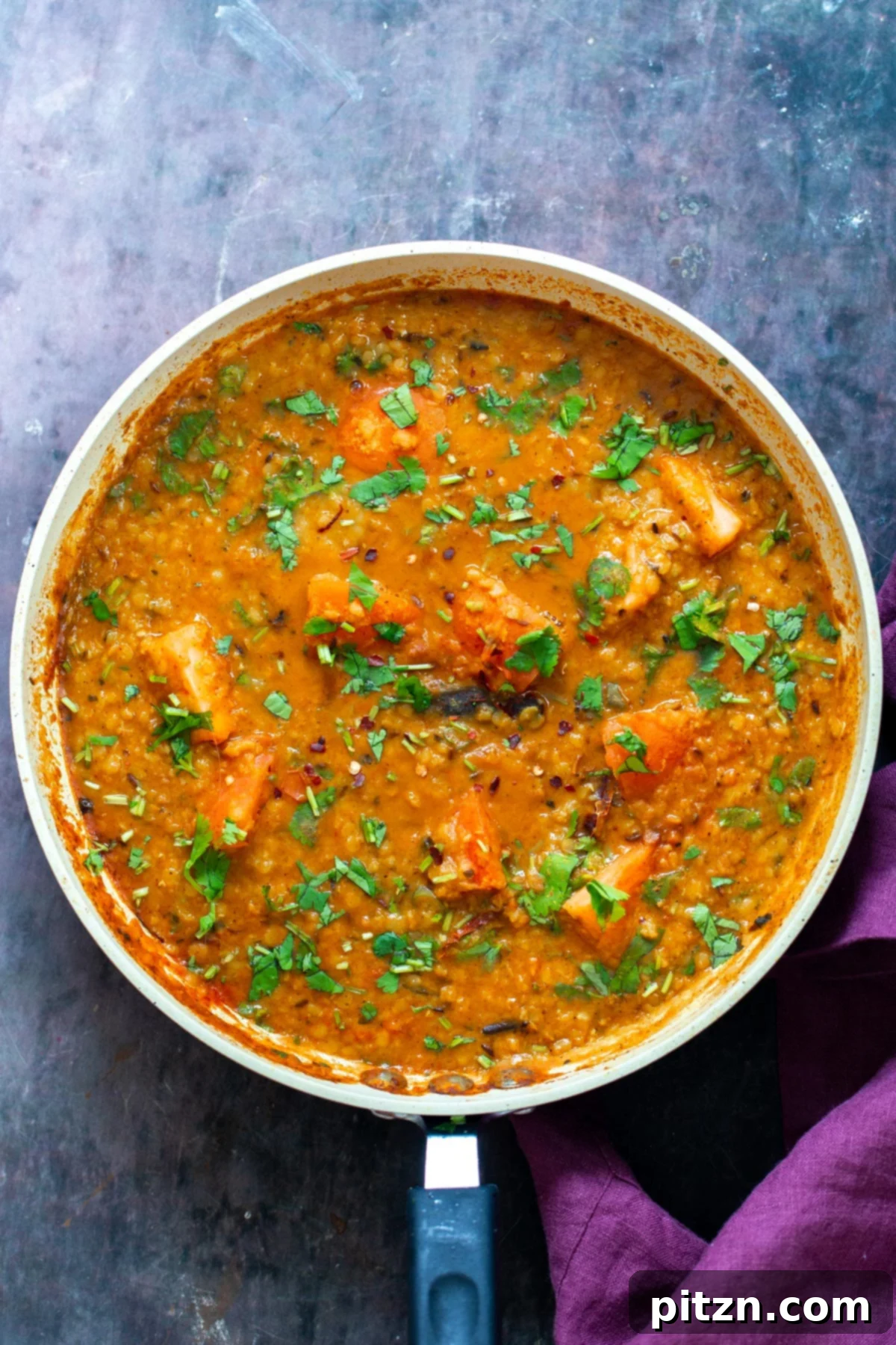 Creamy Plant-Based Dhaba Dal 3 A pan with vibrant vegan butter dal, generously sprinkled with fresh cilantro