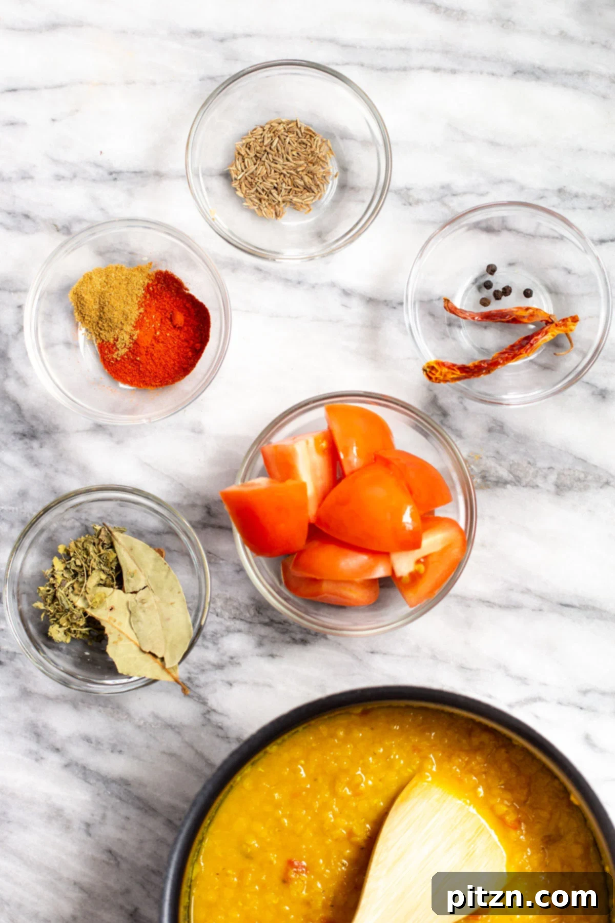 Creamy Plant-Based Dhaba Dal 7 Ingredients laid out for making Dhaba style vegan butter dal on a marble surface