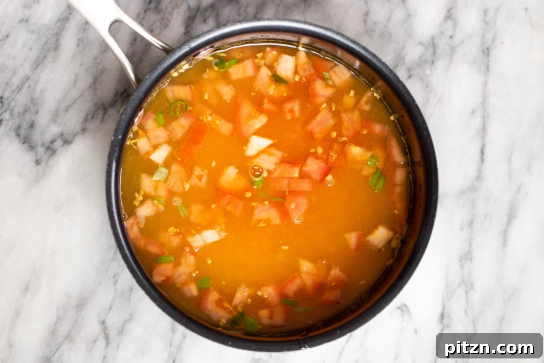 Creamy Plant-Based Dhaba Dal 8 A pot on the stove with tomatoes and red lentils simmering