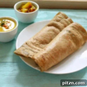 Dosa A Savory Vegan Glutenfree Lentil and Rice Crepe 6 A perfectly folded Dosa on a white plate