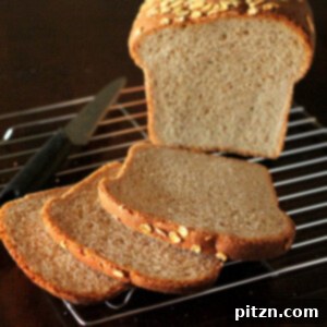 A loaf of everyday sandwich bread cut into slices on a cooling rack