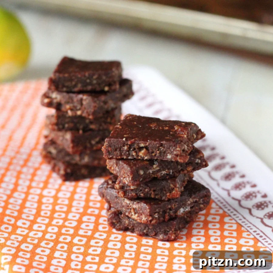 Stacked no-bake chocolate almond bars, showcasing their rich texture and easy preparation