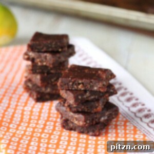 No bake chocolate bars stacked on a piece of orange fabric
