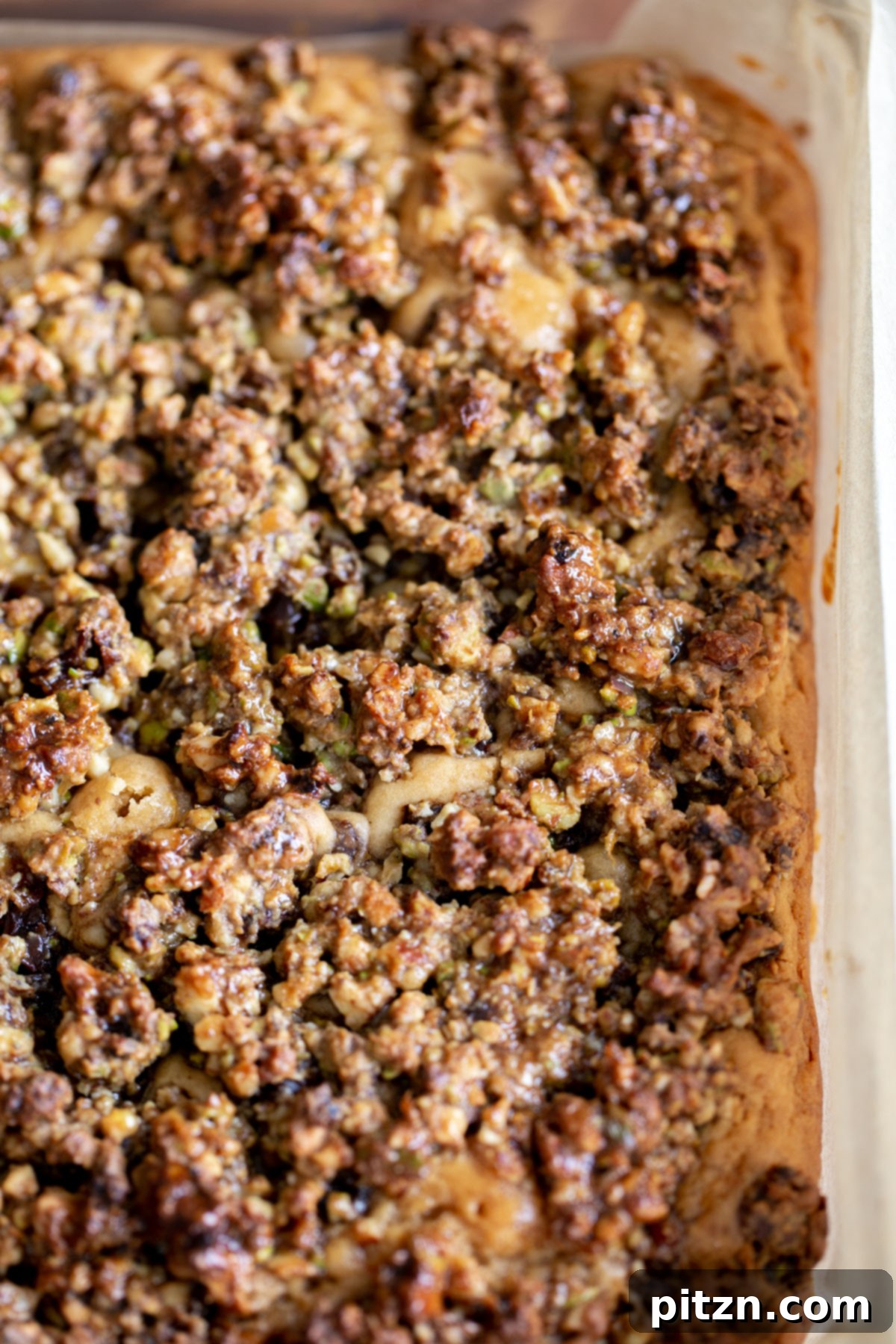 An overhead shot of a vegan baklava cake baked in a square brownie pan, ready to be sliced.