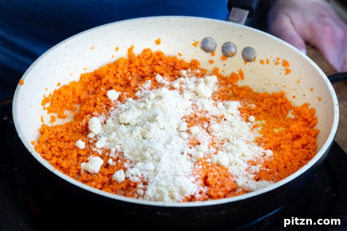 Layered Vegan Carrot Halwa Coconut Burfi 14 shredded carrots and almond flour in a sauteeing pan