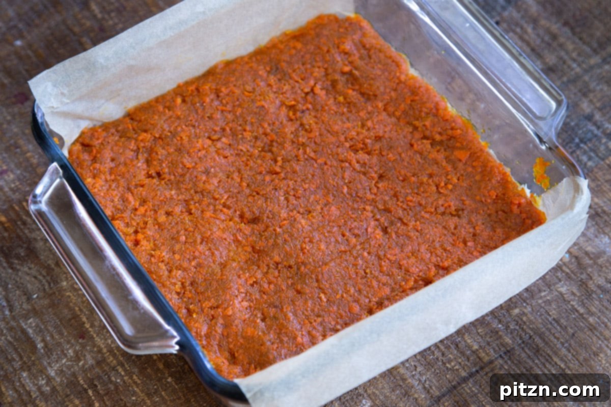 Layered Vegan Carrot Halwa Coconut Burfi 19 layered carrot halwa coconut burfi bars in a glass pan