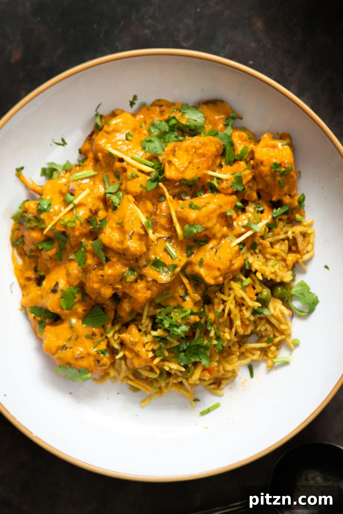 Flavorful Lasooni Vegan Chicken Curry, Entirely Tomato-Free 2 A plate of Indian vegan Lasooni Chicken curry with crispy tofu, garnished with fresh cilantro.