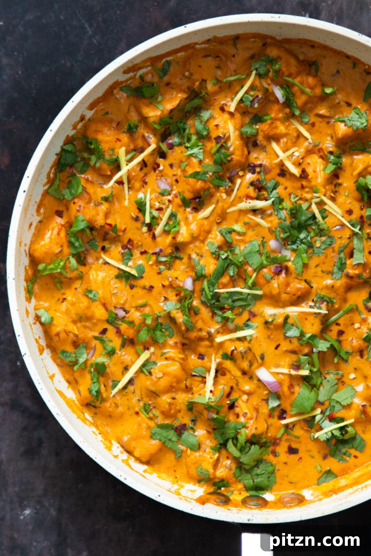 Flavorful Lasooni Vegan Chicken Curry, Entirely Tomato-Free 16 A large pan showcasing creamy vegan Lasooni Tofu Curry, beautifully garnished with julienned ginger and fresh chopped cilantro.