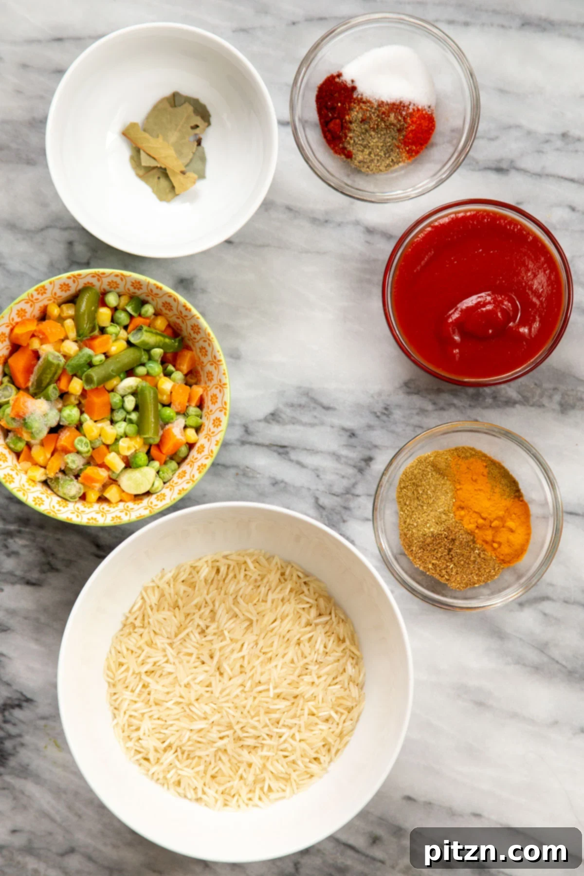All the fresh and pantry ingredients laid out before making the baked masala rice casserole.